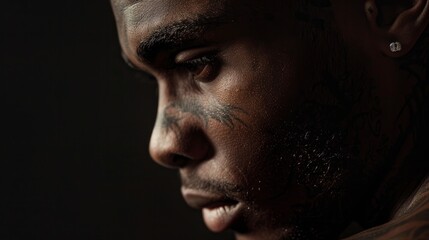 medium: professional photography, up close gorgeous 25-year-old African-American man with a tattoo on his neck, dressed in black, with captivating eyes, studio lighting with a black background