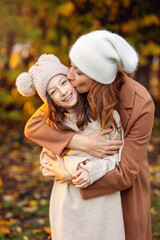Mother and daughter smiling and hugging