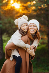 Mother and daughter smiling and hugging