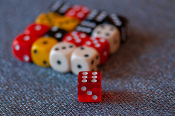 Close-up of colored dice sitting on a tablecloth