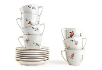 Coffee Tea cups and plates isolated on white background. Heap of vintage cups and saucers.