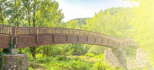 Wooden bridge in forest of Spain on soft sunlight