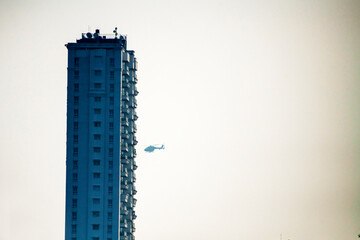 A helicopter flying like 9/11 Twin tower attack style - obrazy, fototapety, plakaty