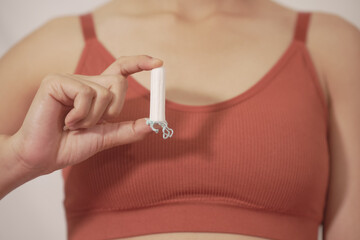 woman wearing underwear White holds a menstrual tampon. white background