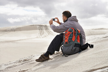 Phone, photography or man in a desert for travel, adventure or profile picture in nature....