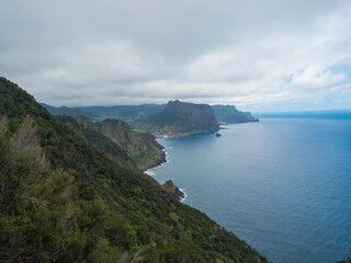 Fototapeta na wymiar Views from Vereda do Larano coastal hiking trail. Cliffs atlantic ocean and green tropical vegetation. Madeira island, Portugal, Europe.