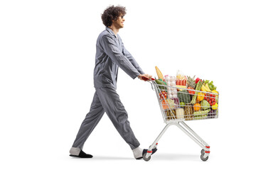 Man in pajamas pushing a shopping cart with food
