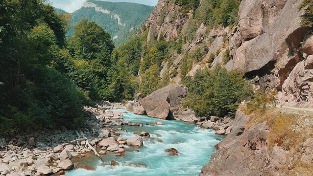 The Bolshaya Laba River. A mountain emerald river in a narrow, sunlit canyon. Bolshaya Laba River near the village of Psemen in Karachay-Cherkessia, Russia. Panoramic view. 4K