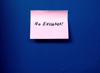 Handwritten text message on blue wall background  NO EXCUSES , concept of Living in present /doing...