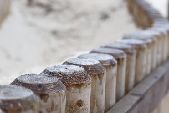 sandy wooden fence on the beach