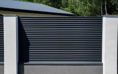 Modern metal fence with shutters