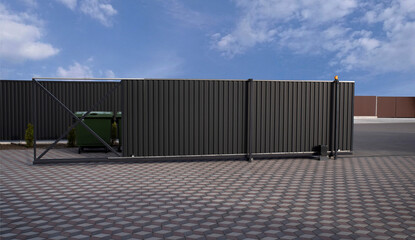 Automatic sliding metal gate and blue sky