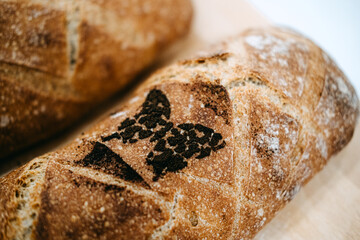 Artisanal Bread Loaves on Wooden Board. Slow foods. Home-cooked and authentic Bread