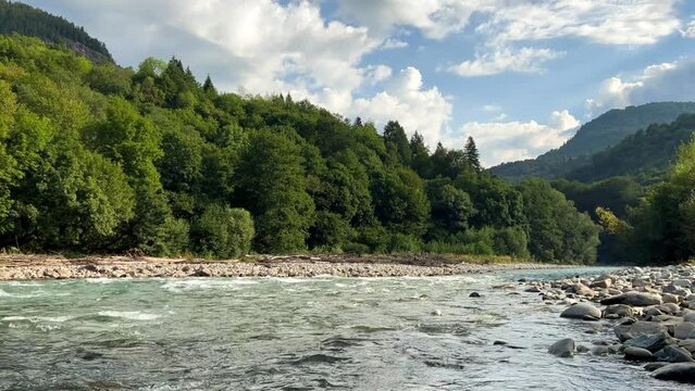 The Bolshaya Laba River. A mountain emerald river in a narrow, sunlit canyon. Bolshaya Laba River near the village of Psemen in Karachay-Cherkessia, Russia. Panoramic view. 4K