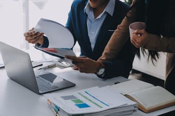 Business team working with new startup project plan and discussion information for financial strategy with laptop and digital tablet in a modern business lounge.