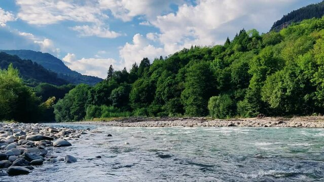 The Bolshaya Laba River. A mountain emerald river in a narrow, sunlit canyon. Bolshaya Laba River near the village of Psemen in Karachay-Cherkessia, Russia. Panoramic view. 4K