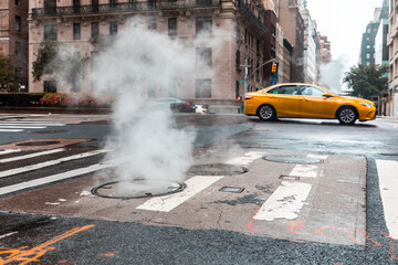 Steamy street scene with yellow taxi in New York - obrazy, fototapety, plakaty