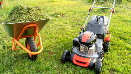 lawn mower on a green lawn on a sunny