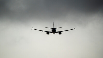 passenger plane in the sky at sunset in