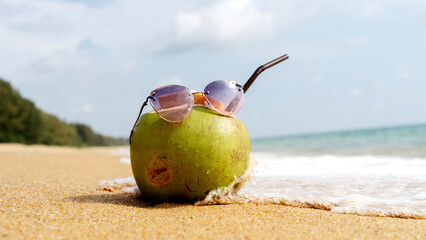 coconut cocktail on a sandy beach by the
