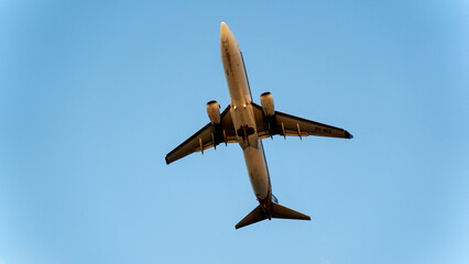 passenger plane in the sky at sunset in