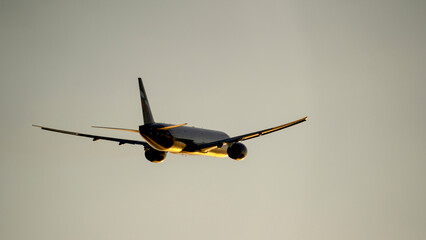 passenger plane in the sky at sunset in