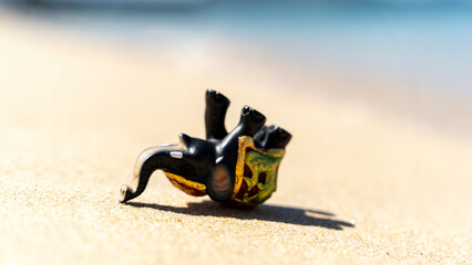 Elephant sunbathing on the beach figurine