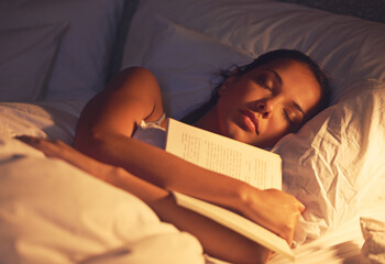 Woman, sleep and book in bed and resting, dreaming female person or night lamp for story and novel....