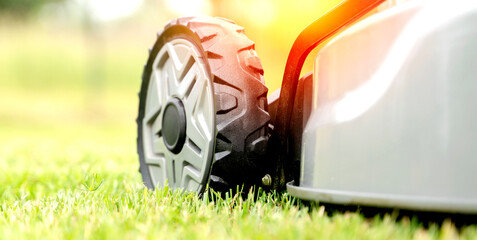 lawn mower on a green lawn on a sunny day in