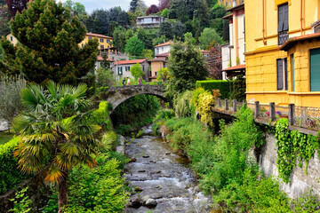 Menaggio, province Como, Lombardy, northern Italy, Europe - western shore of Lake Como, view for the historic, residential part of the city overgrown with all different kinds od plants and trees - obrazy, fototapety, plakaty