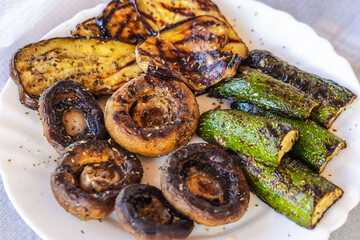 Grilled vegetables - mushrooms, zucchini and eggplant on a plate in Cyprus island country