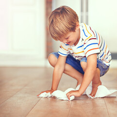 Boy, floor and cleaning in home for mess, spill or household chores for childhood development....