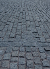 Close up cobblestone pavement, Granite cobblestoned pavement background. Stone pavement texture. Abstract background of cobblestone pavement close up. Seamless texture