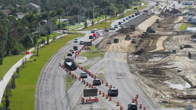 Highway construction in North Port, Florida. Development of American road with moving traffic cars. City transportation improvement.