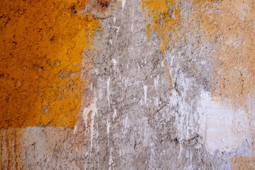  plastered concrete wall with yellow paint in some places