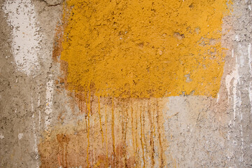  plastered concrete wall with yellow paint in some places