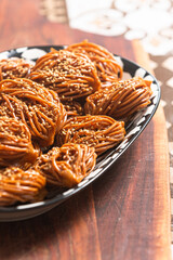 A tantalizing plate of Chebakia : golden-brown, honey-coated Moroccan pastries adorned with almonds
