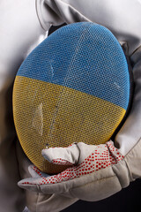 Ukrainian fencer on a black background