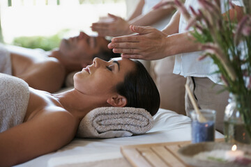 Sleep, head massage and couple relax in spa for care of body with rest on table of retreat for...