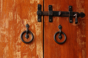 elements of antique metal parts on a wooden door