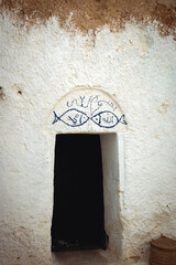 Signs in traditional Berber cave dwelling near Matmata city, Kebili Governorate, Tunisia