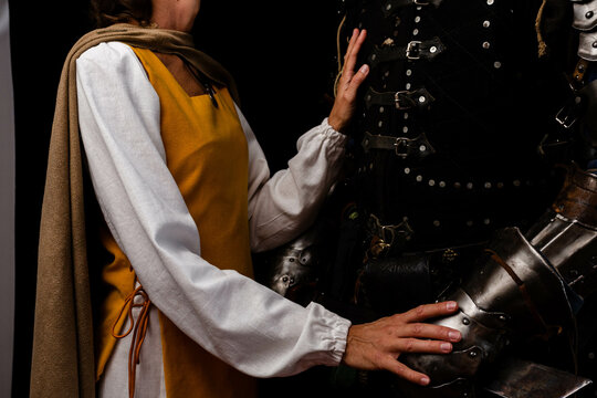 Knight and his lady in medieval costumes. Artistic close-up photo. No face.
