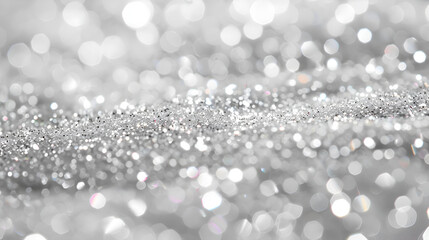 Silver glitter sparkles on a white background, Silver and white bokeh lights defocused. abstract background.
