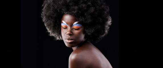 Fototapeta premium African woman, makeup and eyeshadow with beauty, skin and creative with studio and color. Model, closeup and face paint for artistic, contrast and aesthetic for glamour isolated on black background