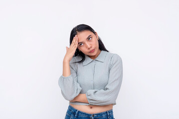 Annoyed young asian woman facepalms, expressing frustration and disbelief, with hand on forehead,...
