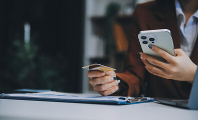 Hands holding plastic credit card and using laptop. Online shopping concept. Toned picture