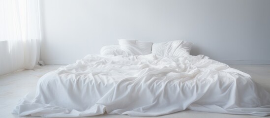 A messy bed with white sheets and pillows in a bedroom, showcasing signs of a long nights sleep and waking up in the morning.
