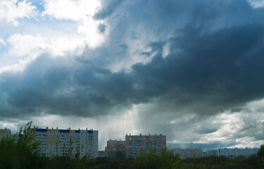 Menacing rain clouds hung over multi-storey residential buildings
