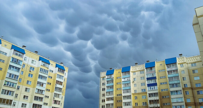 Rare and menacing mammatus clouds loom over residential high-rise buildings
