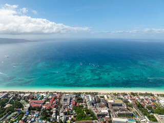 Scenic white sand beach with clear turquoise water in Boracay, Philippines.